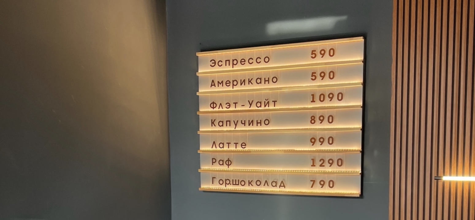 Интерьер Sat Coffee: тёплая подсветка меню и деревянные панели